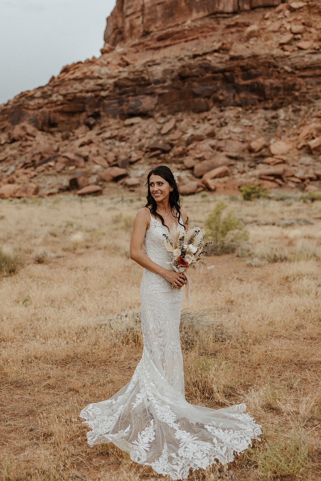bride poses in front of the stunning red rocks 
