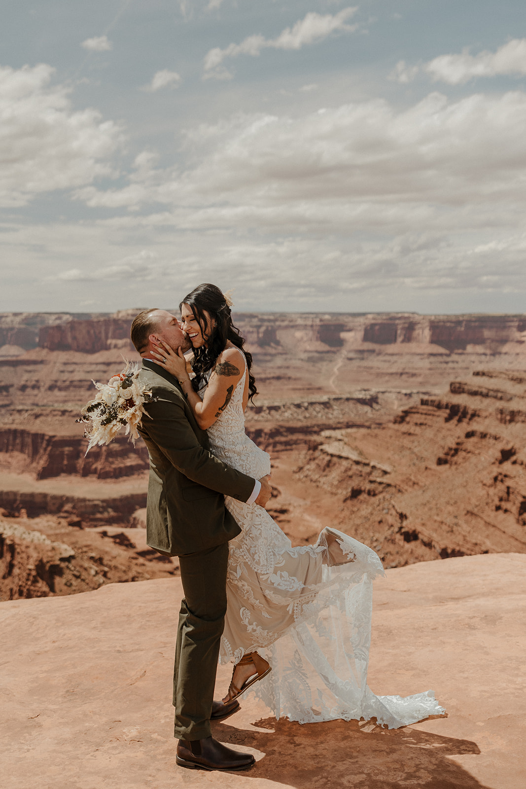 bride and groom pose with the stunning Arizona canyons in background