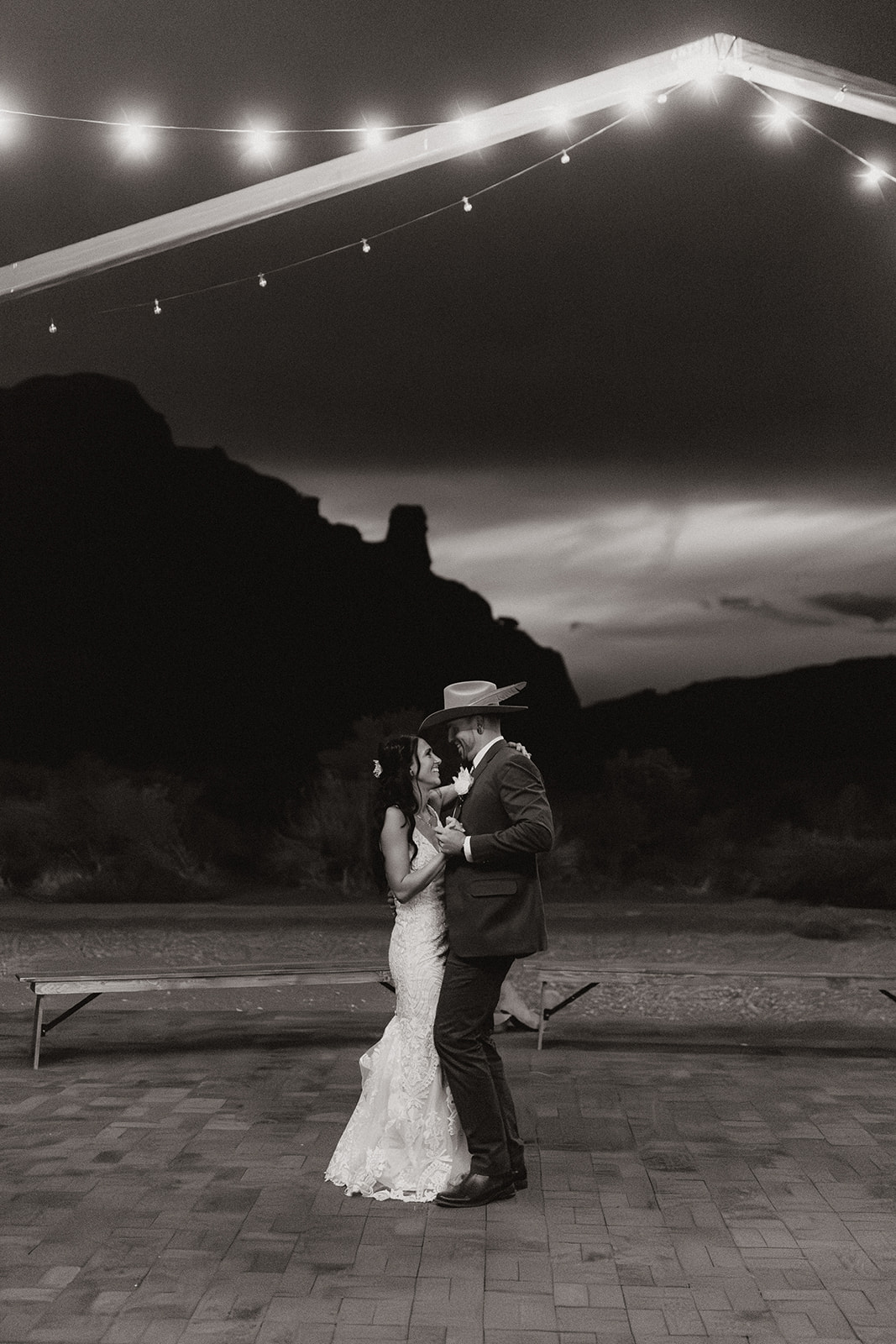 bride and groom share their first dance together with the dreamy Arizona sky in the background