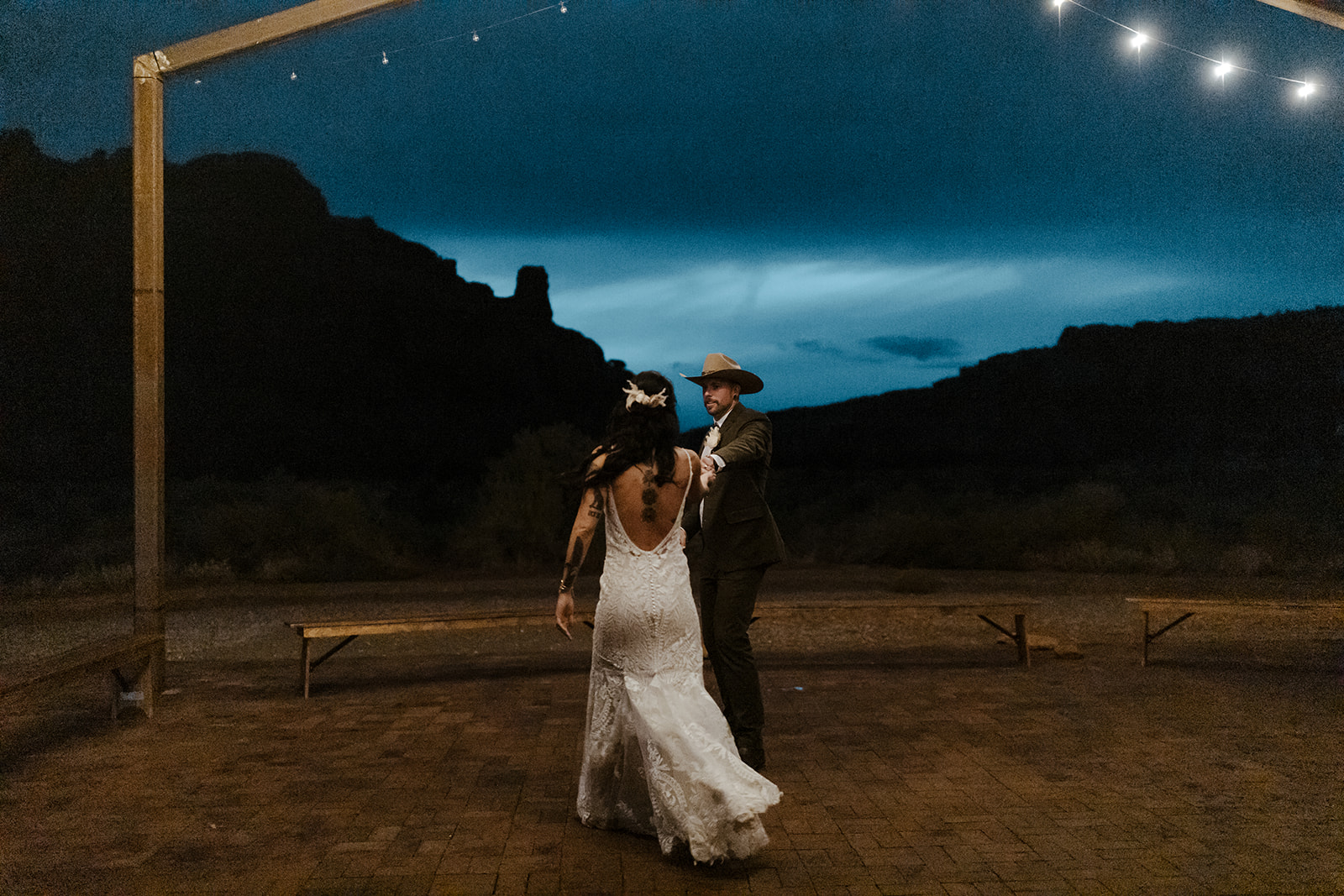 bride and groom share their first dance together with the dreamy Arizona sky in the background