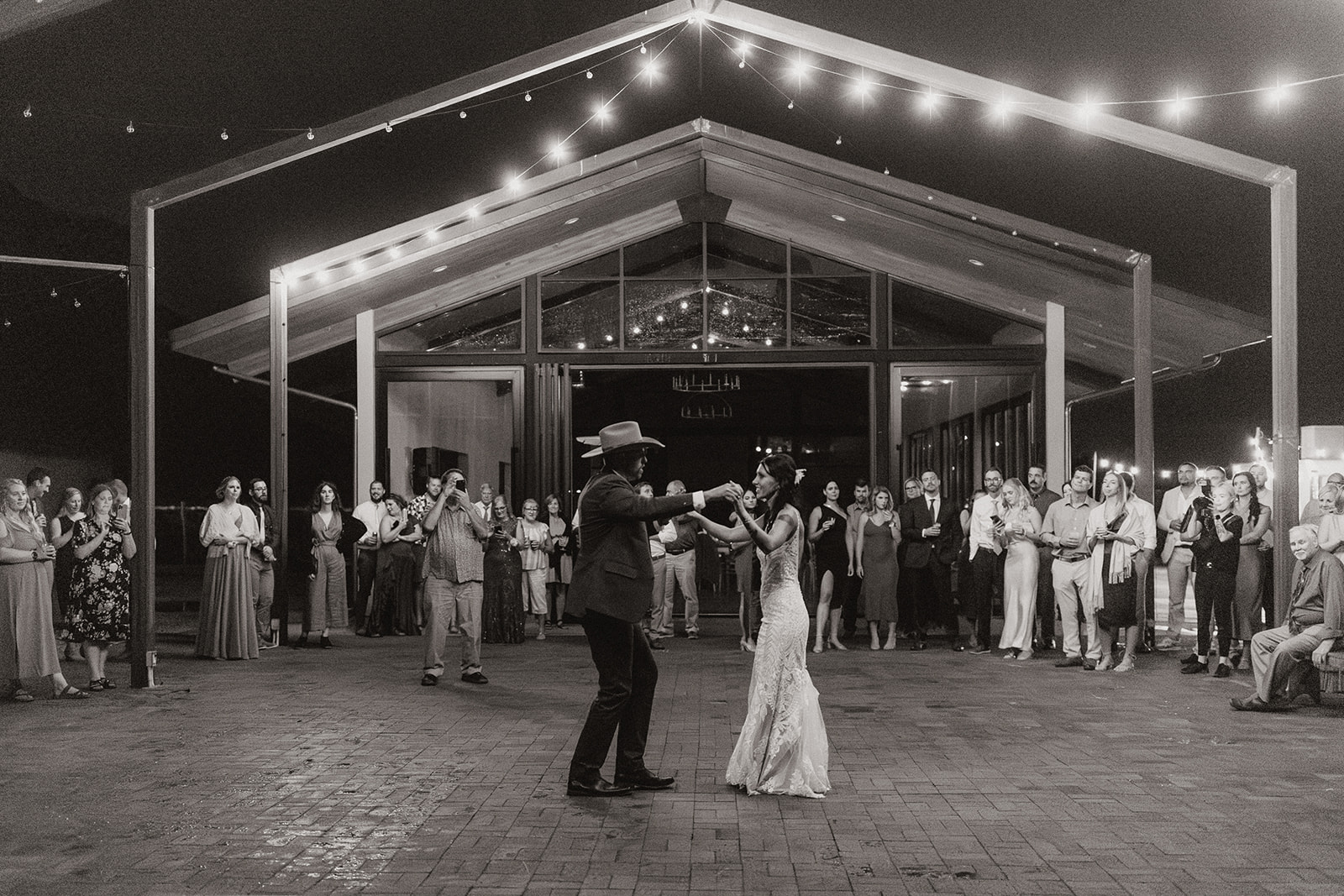 bride and groom share their first dance in front of their guests