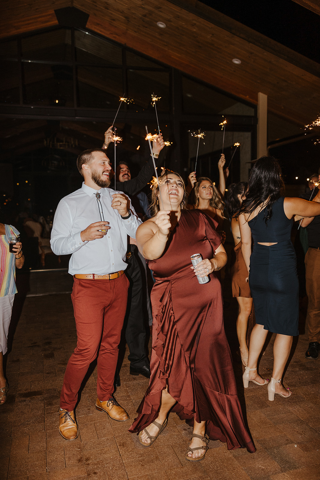 guests celebrate with  with sparklers as they dance at the dreamy Arizona wedding reception