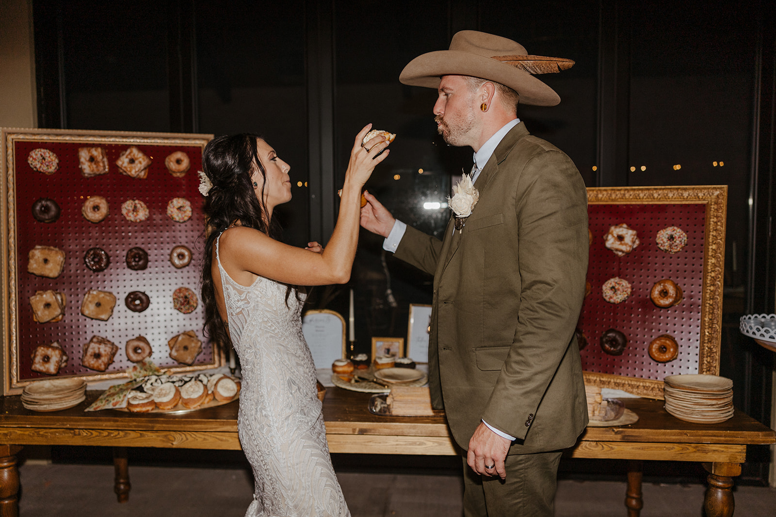 bride and groom feed each other a bite of their wedding cake 