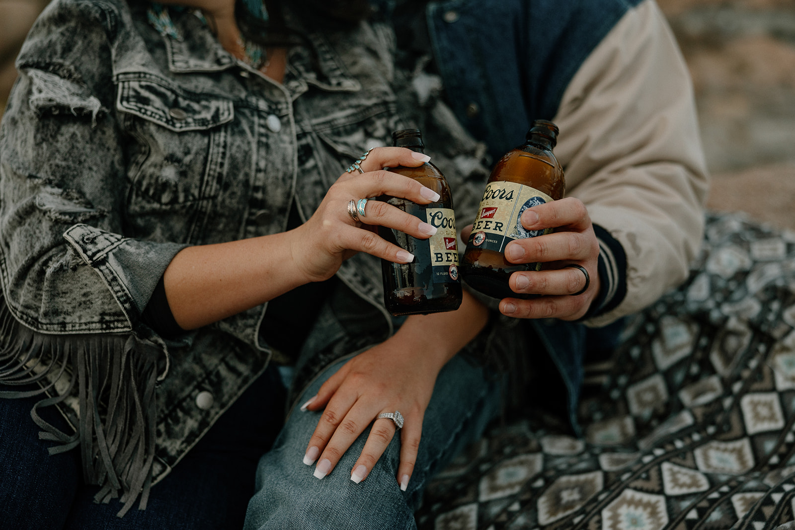 detail photo of a an Arizona couple sharing beers during their Arizona engagement photoshoot
