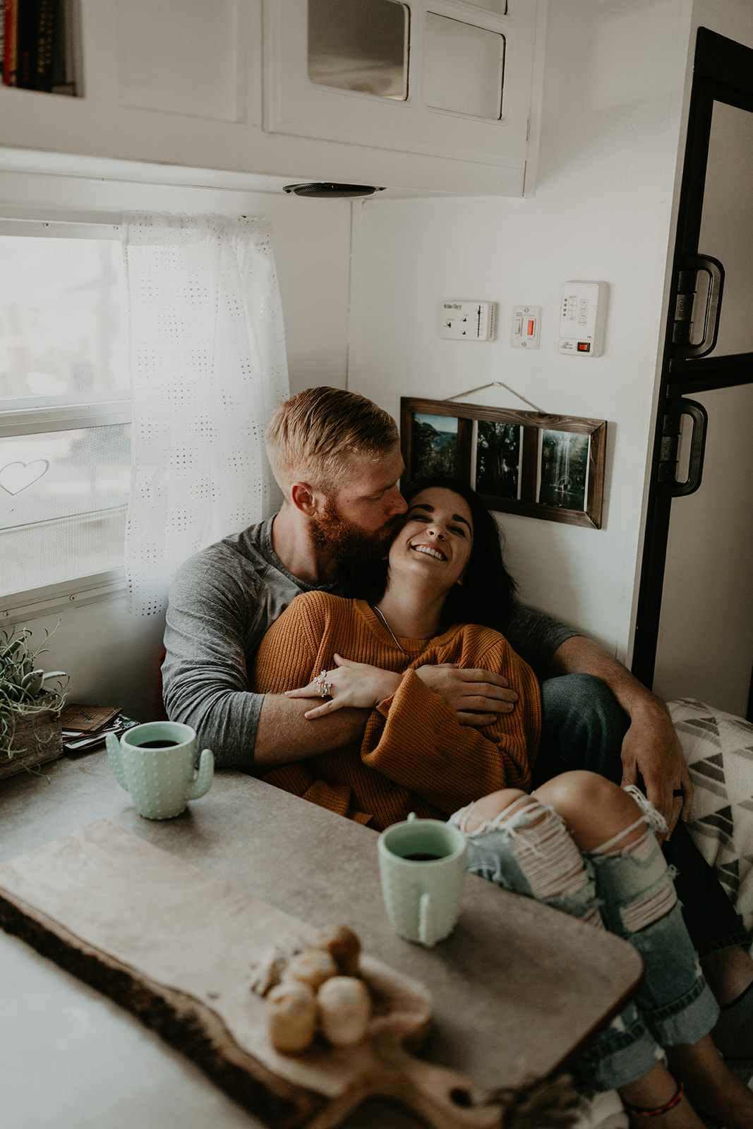 couple pose at the dining room table of their home