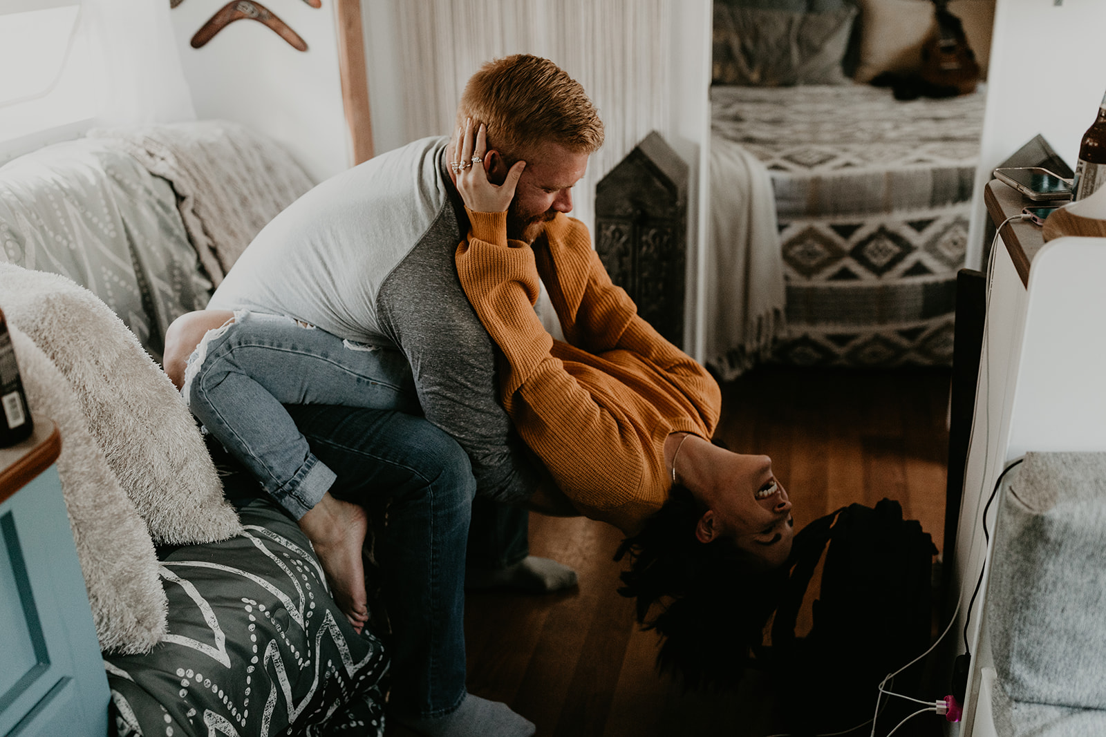 couple poses on the couch together during their in home couples photoshoot