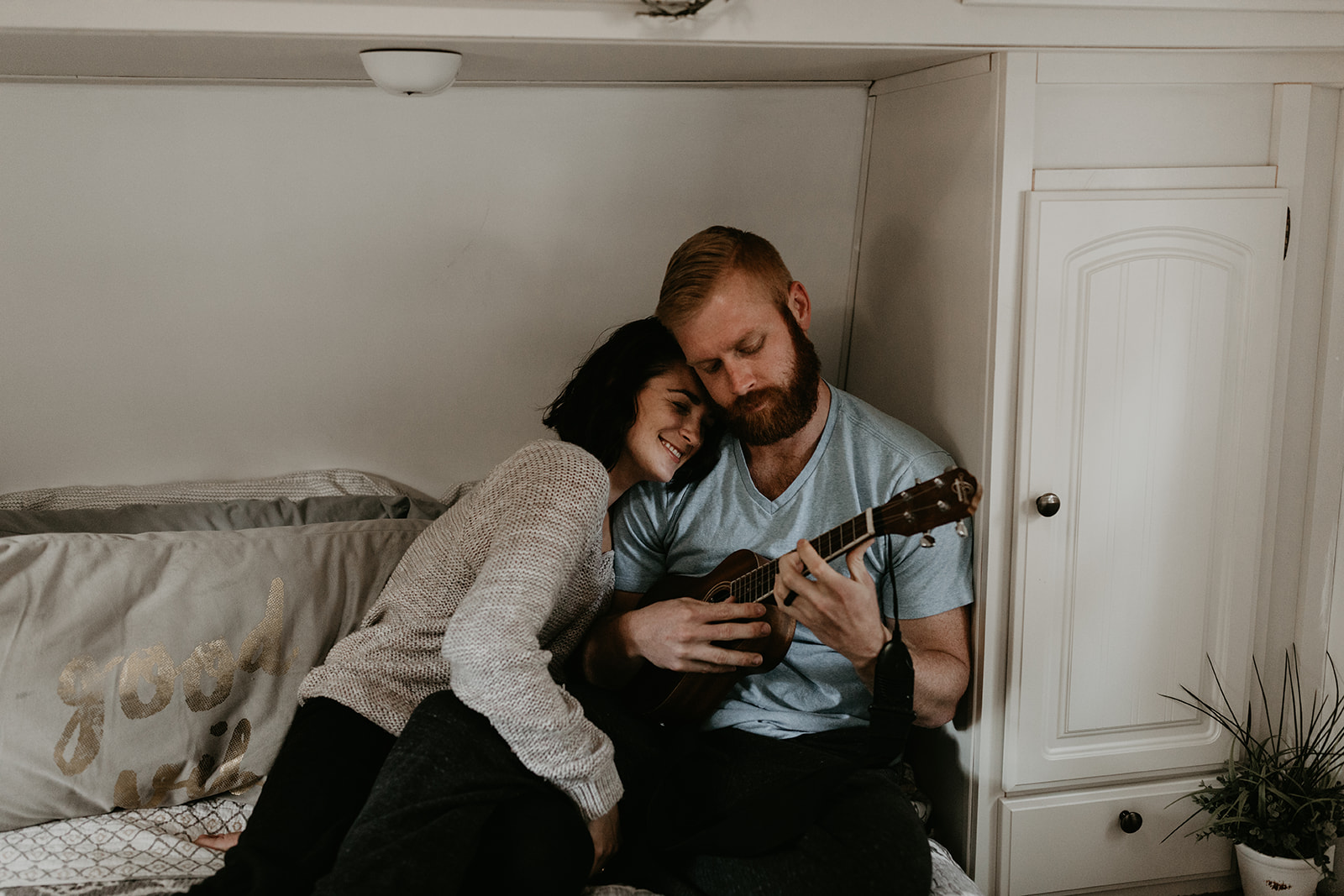 couple pose on the bed together during their couple photoshoot ideas at home