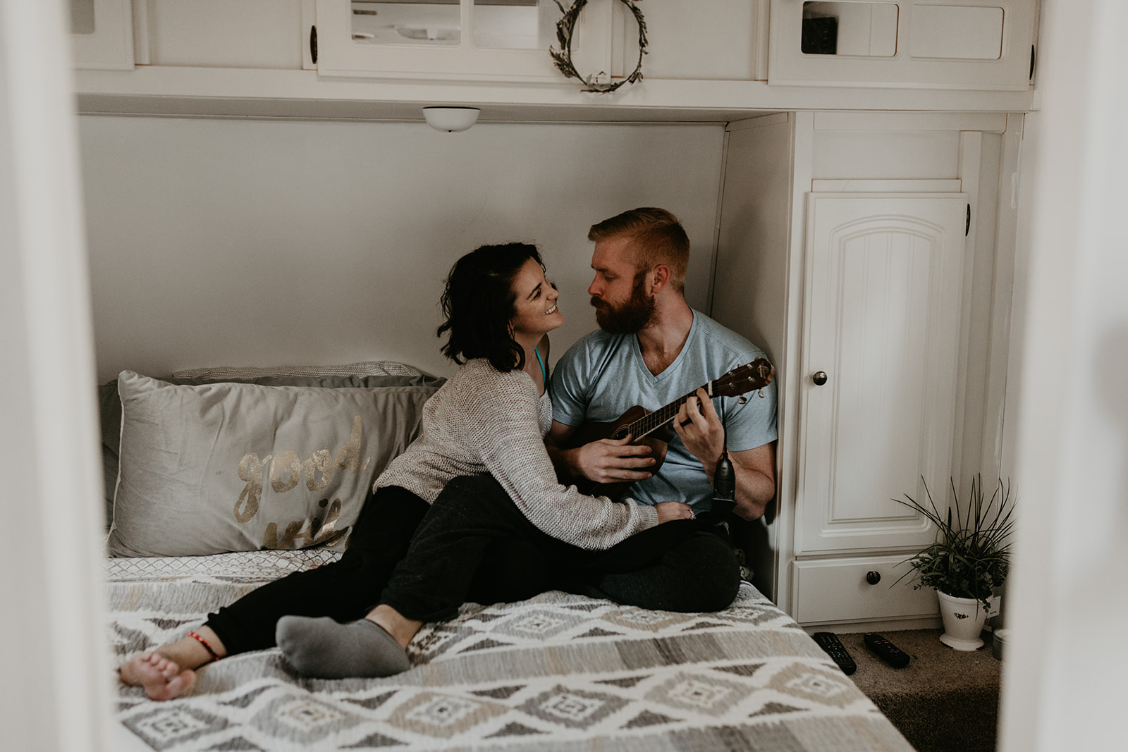 couple pose on the bed together during their couple photoshoot ideas at home