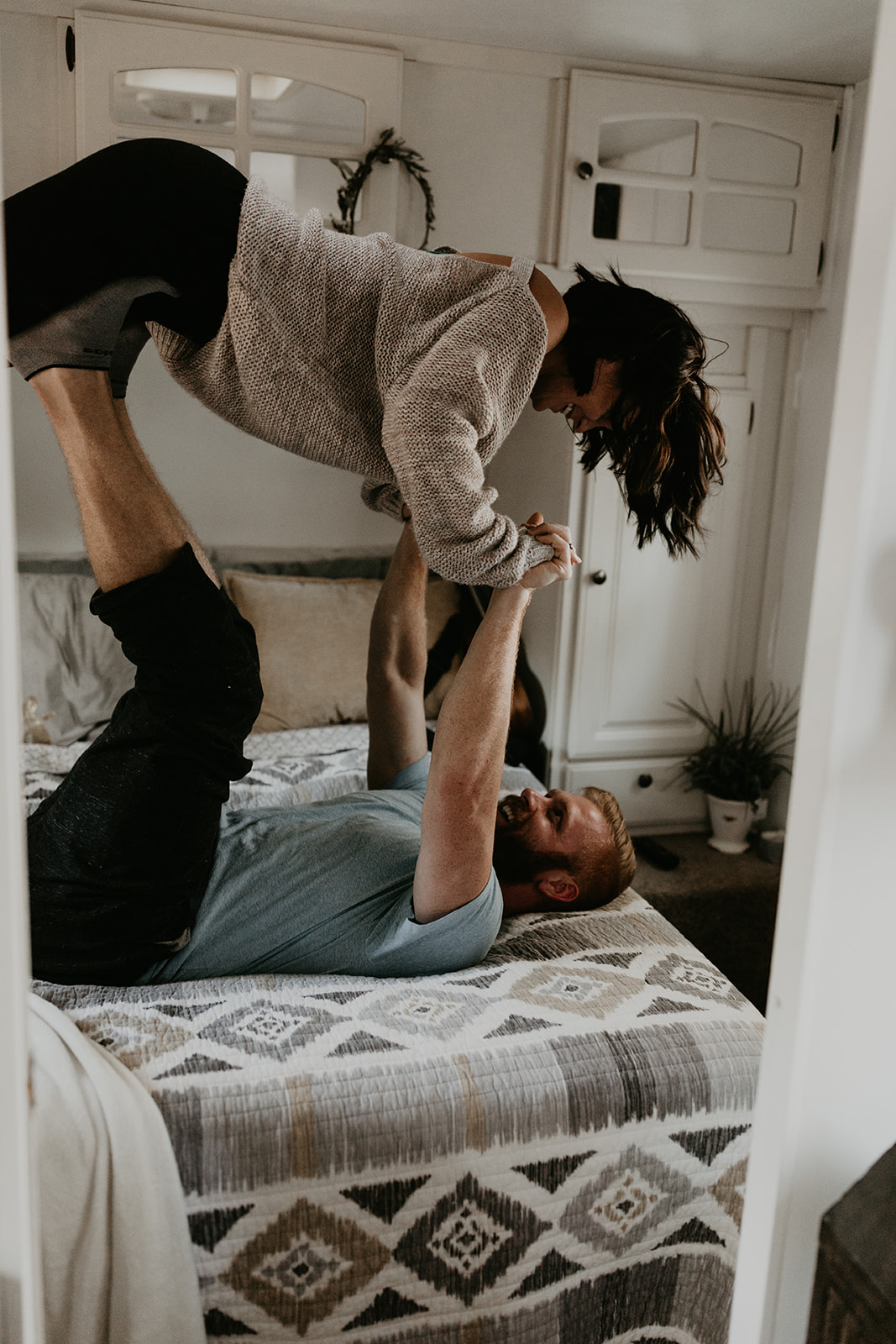 husband and wife pose together in their adorable house