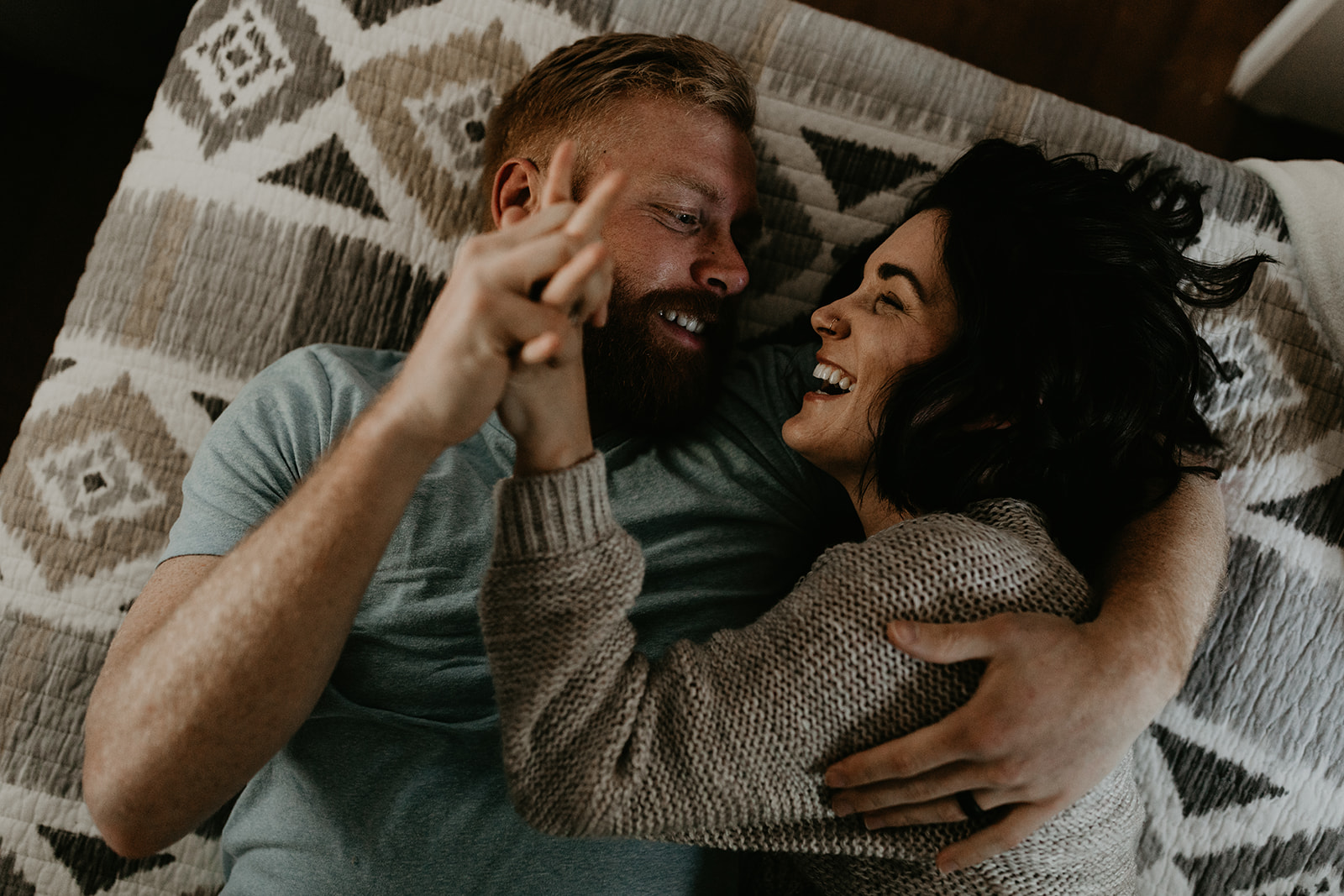 couple pose on the bed together during their couple photoshoot ideas at home