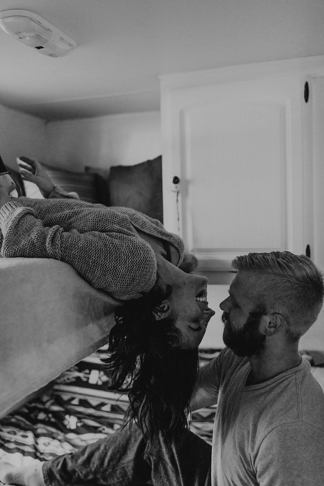 husband and wife pose together in their adorable house