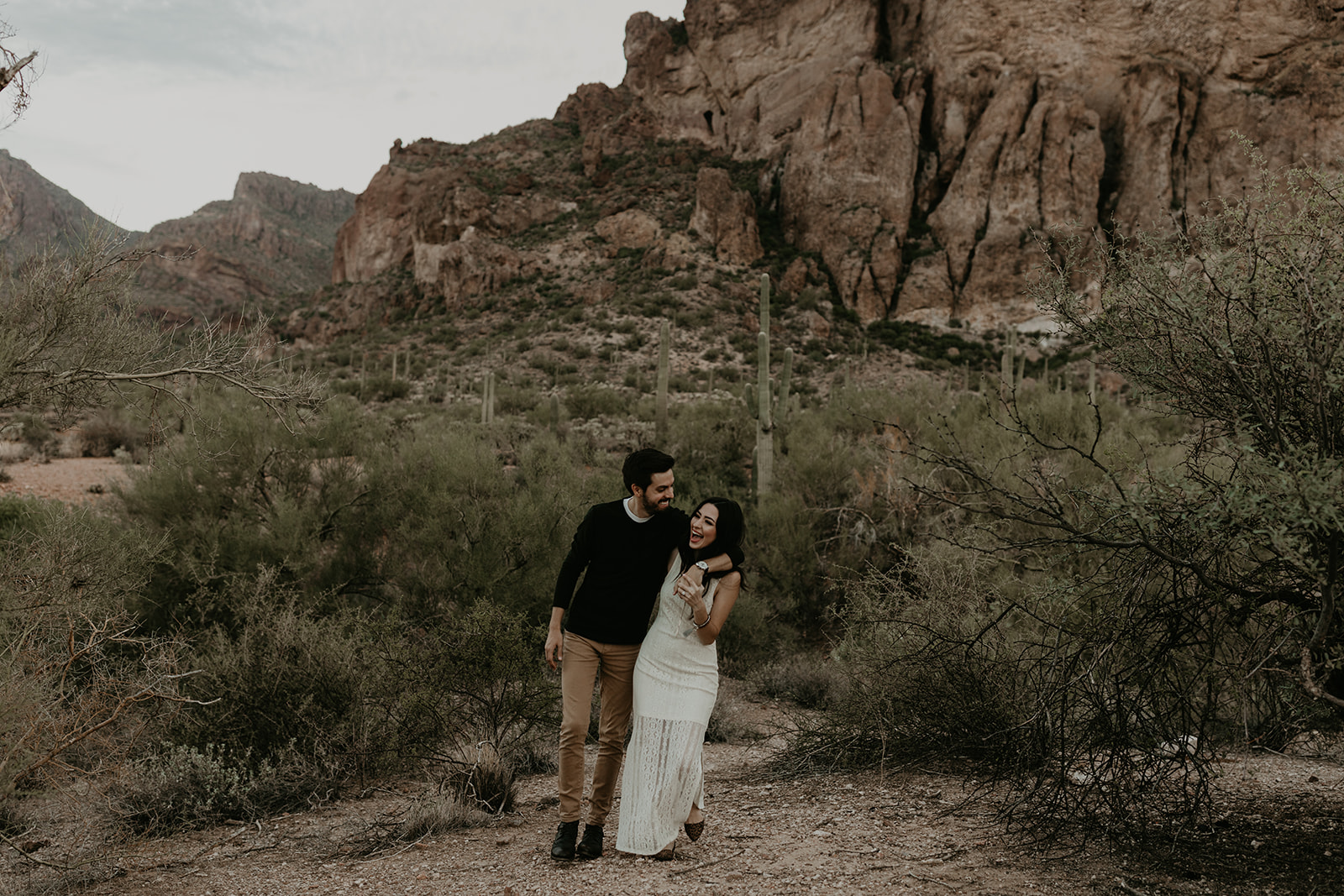 beautiful couple pose together during their Arizona hiking engagement photos