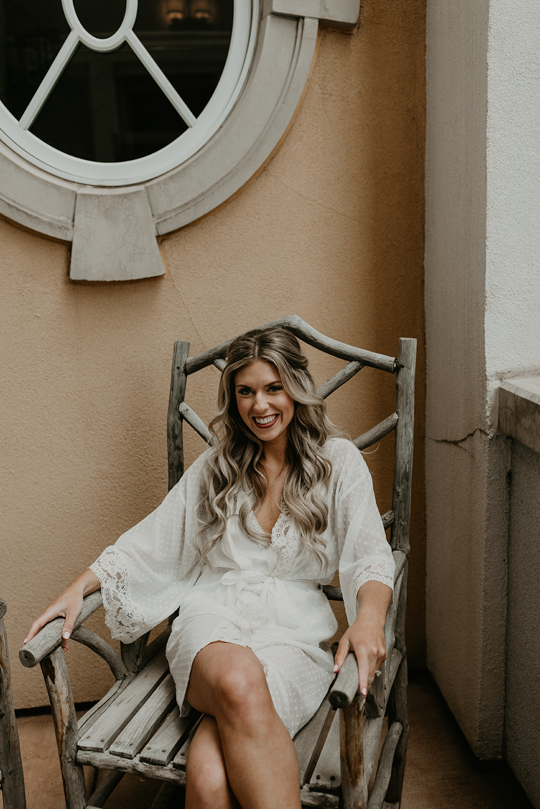 bride sits outside on the patio before her big day