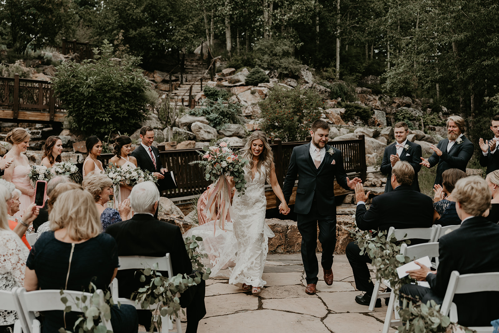 husband and wife exit their dreamy Betty Ford Alpine Gardens Wedding ceremony