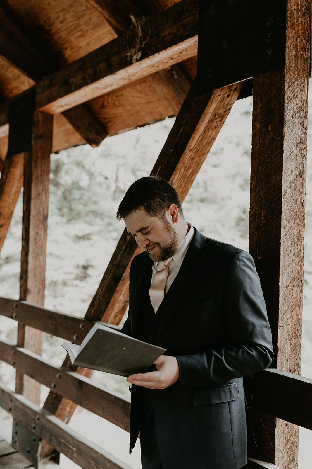 groom smiles as he reads his brides private vows to him