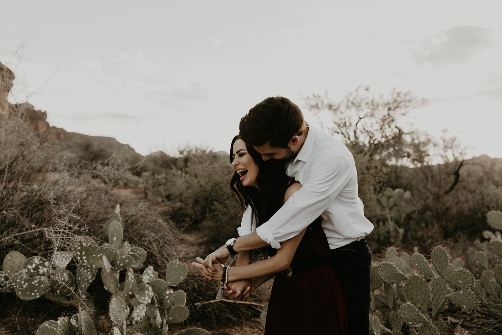 stunning couple pose with the Arizona cactus during their dreamy engagement photos