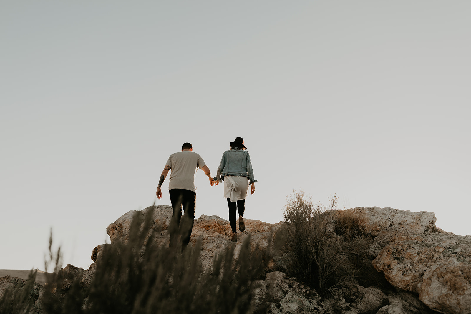 couple pose together on rocks 