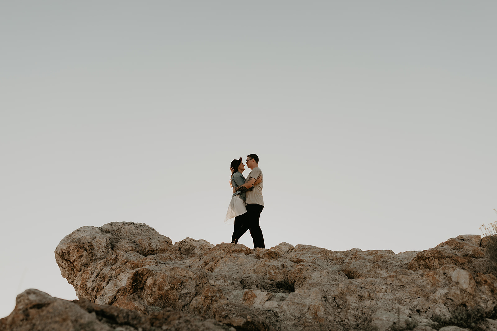 couple pose together on rocks in the beautiful Utah nature during their Engagement photos in Utah