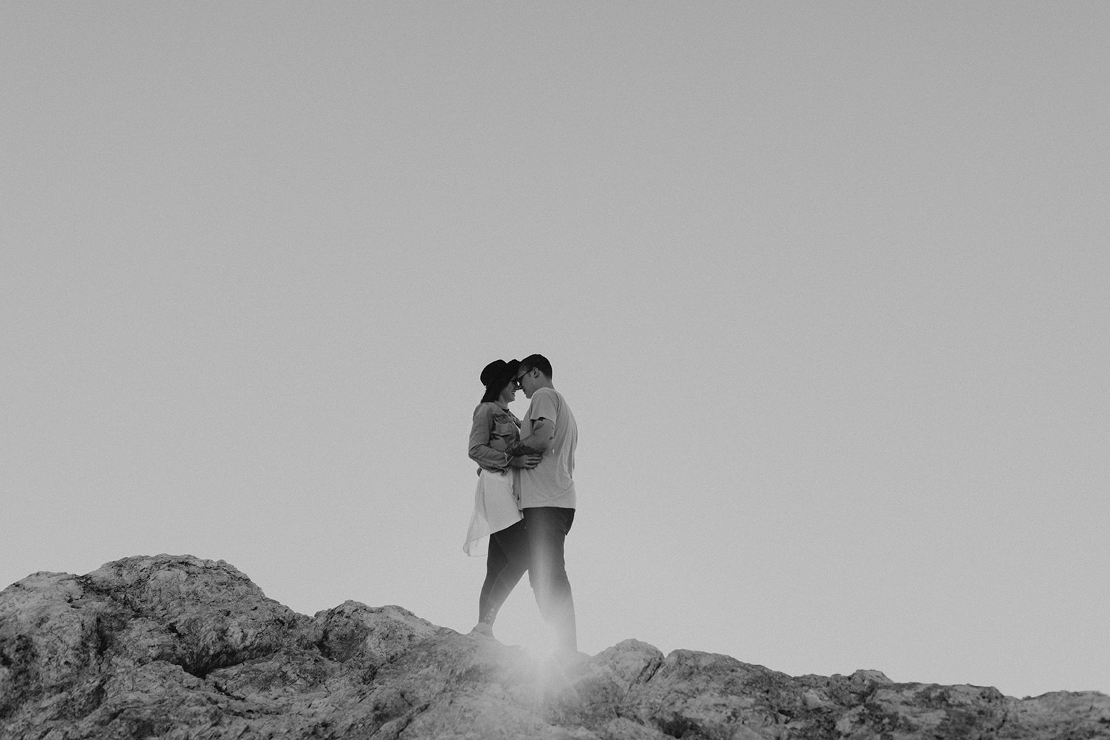 couple pose together on rocks in the beautiful Utah nature during their Engagement photos in Utah