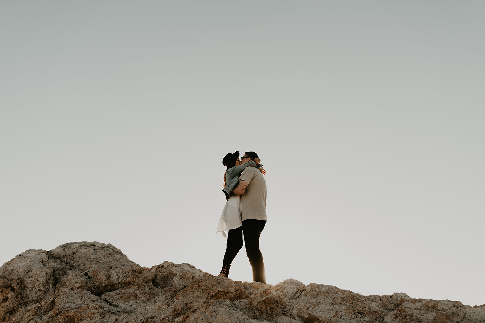 couple pose together on rocks in the beautiful Utah nature during their Engagement photos in Utah