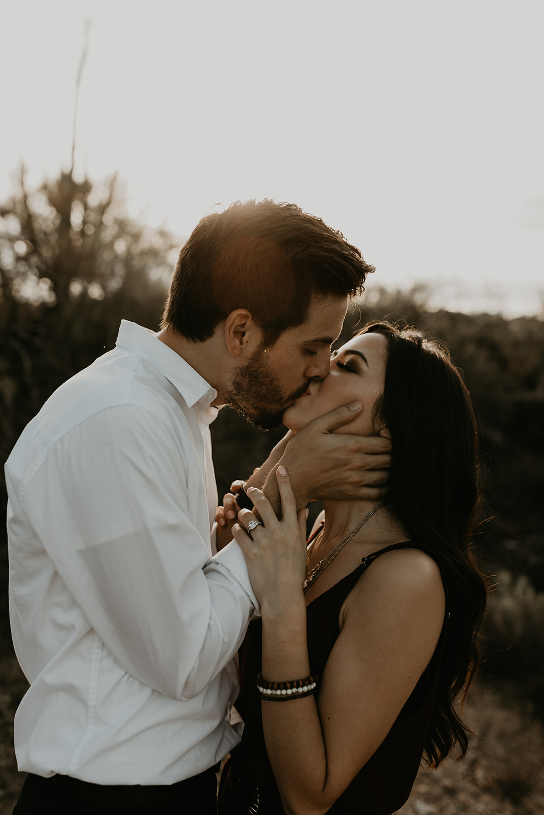 beautiful couple share a kiss during their engagement photoshoot