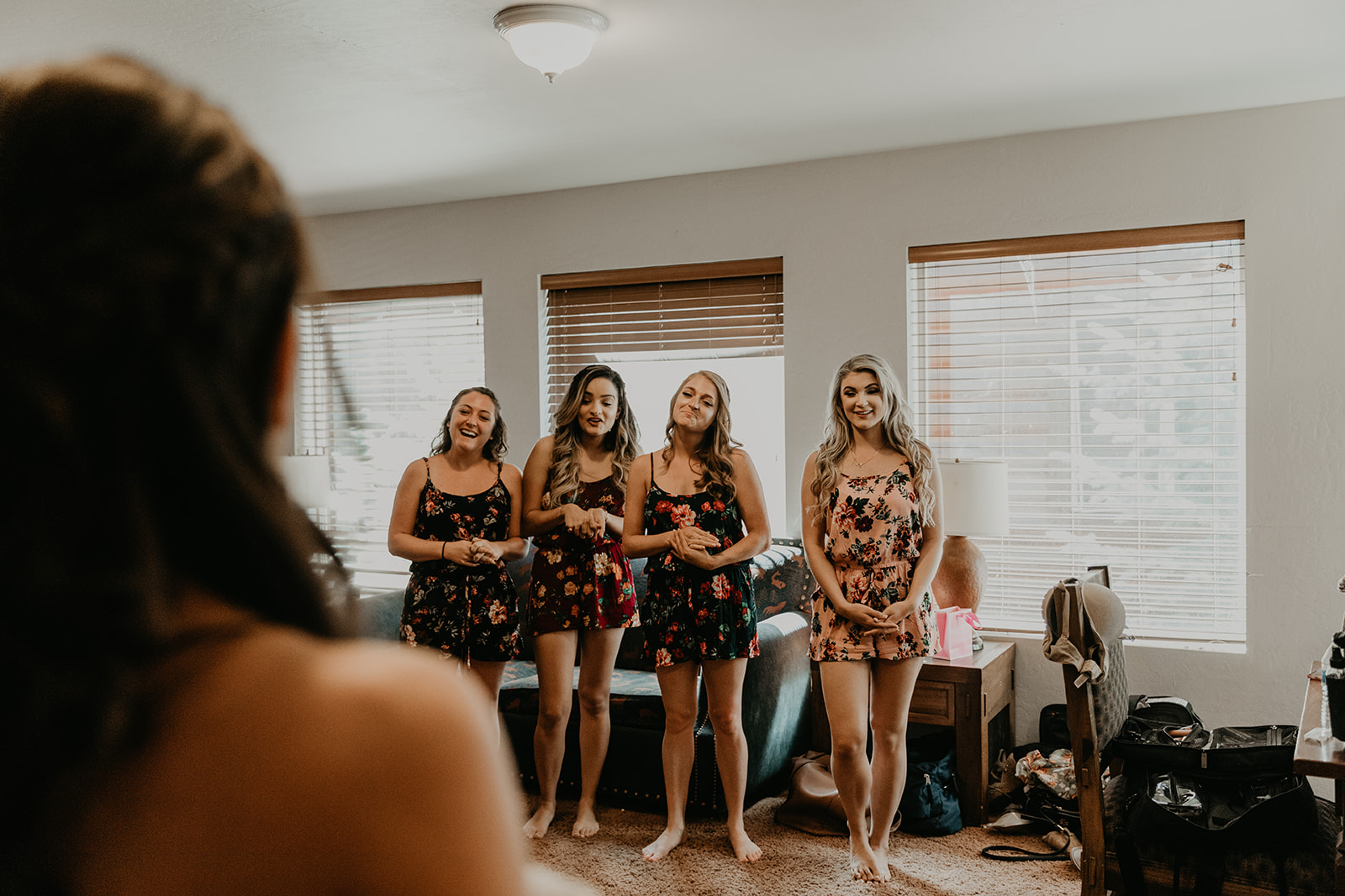 bride poses for a first look with her bridesmaids as they all prepare for the dreamy Mormon lake lodge wedding ceremony