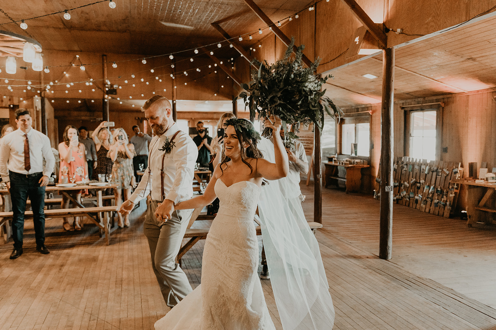 bride and groom enter their dreamy Mormon lake lodge wedding reception