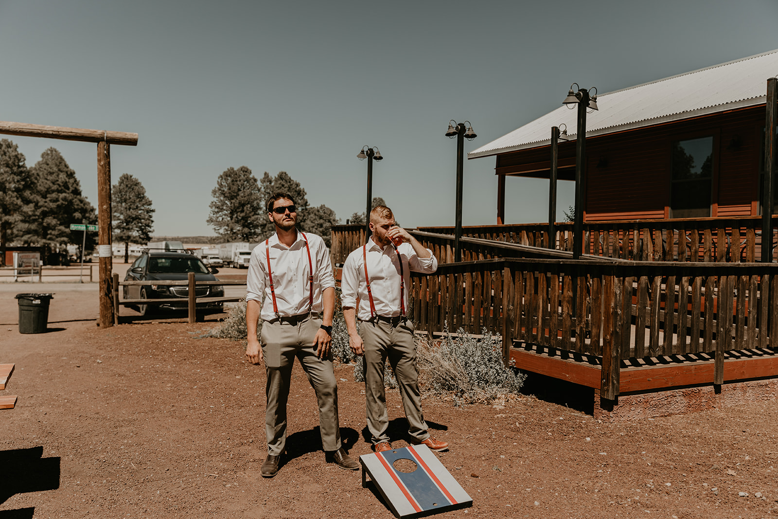 groomsmen play cornhole outside of the dreamy Mormon lake lodge wedding reception 