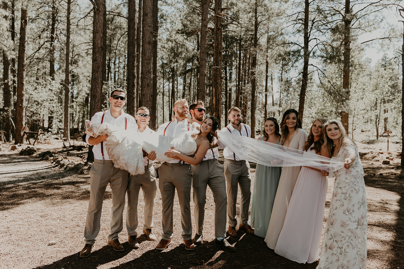 bride is stretched out by her family holding her veil and feet on both ends! 