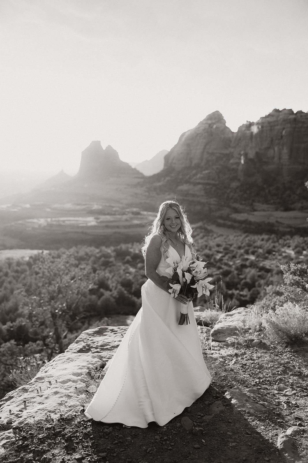 bride poses in front of the stunning Arizona wilderness