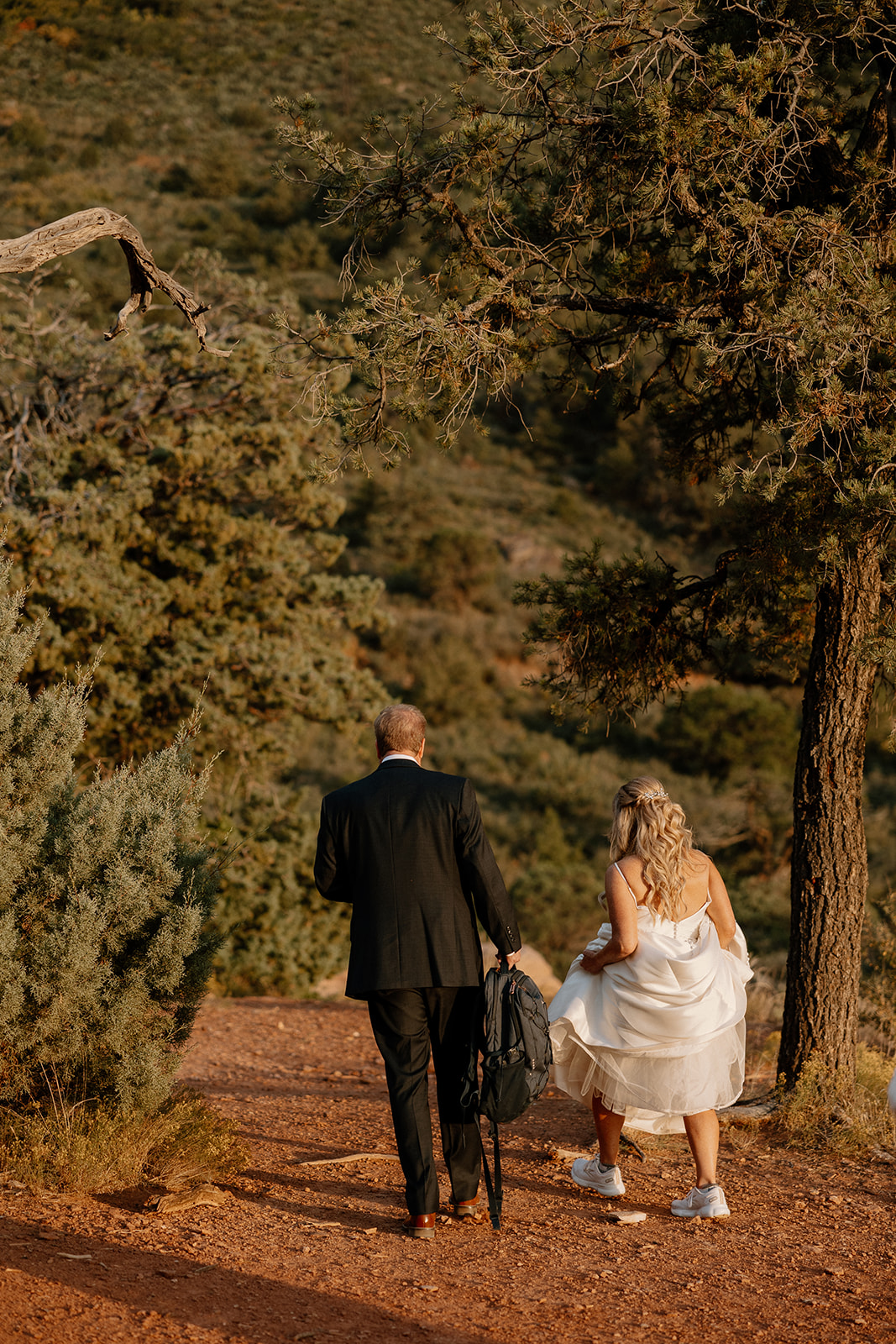 bride and groom walk into the sunset together after their dreamy Arizona wedding ceremony