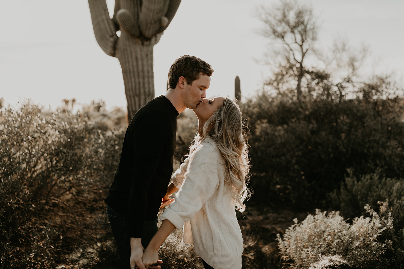 beautiful couple share a kiss together during their lost dutchman state park