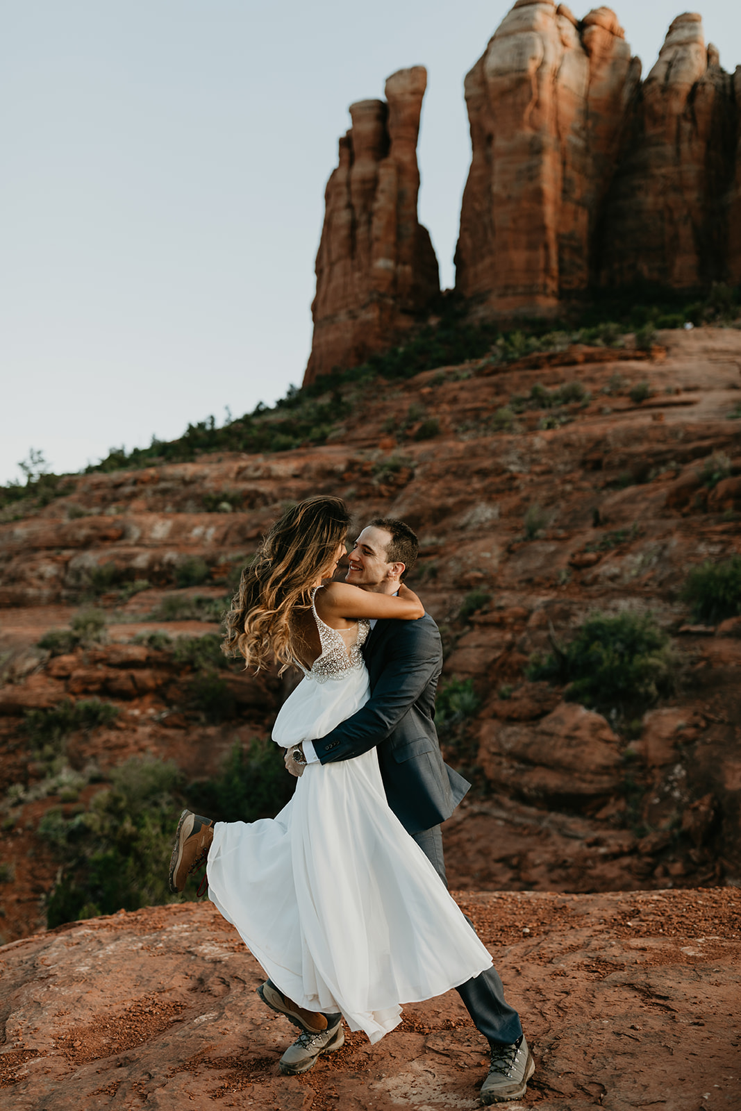 stunning couple pose together for their Sedona cathedral adventure engagement photos