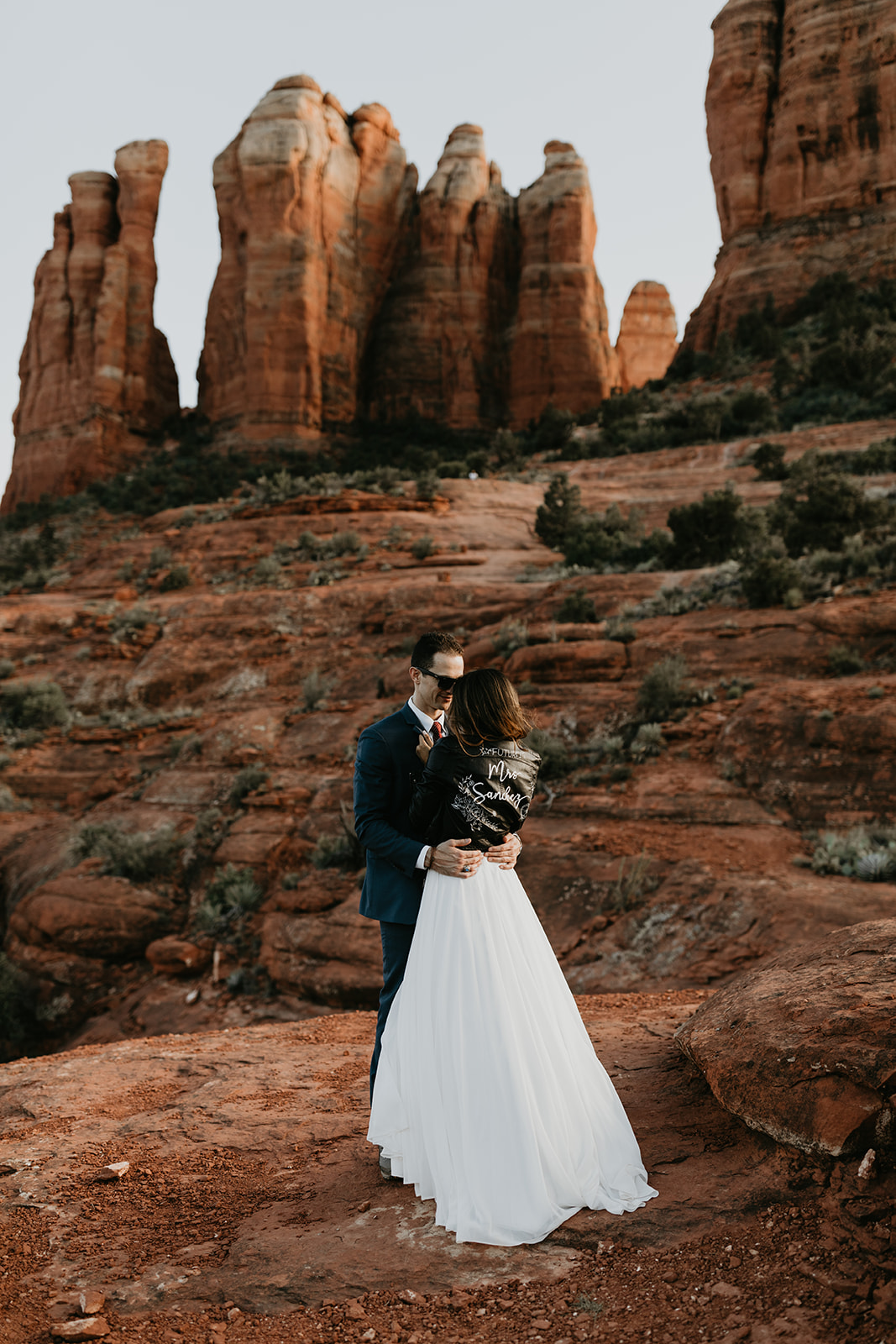 stunning couple pose together for their Sedona cathedral adventure engagement photos