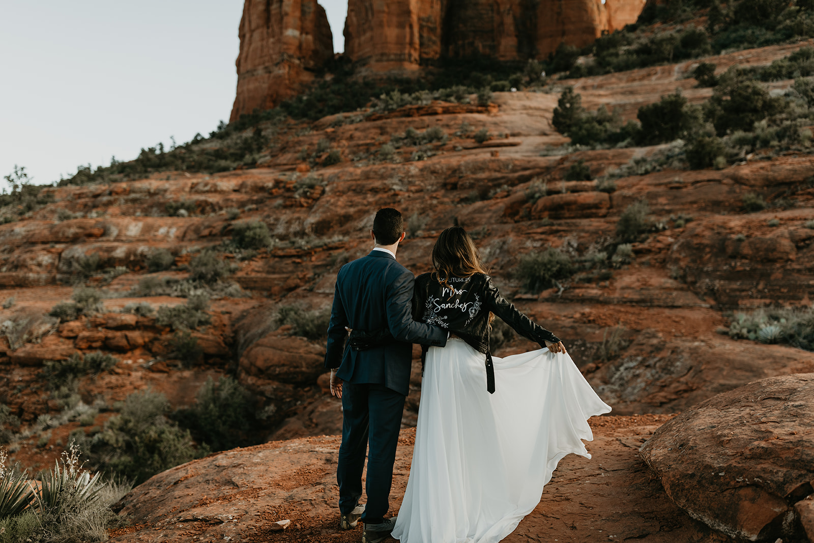 stunning couple pose together for their Sedona cathedral adventure engagement photos