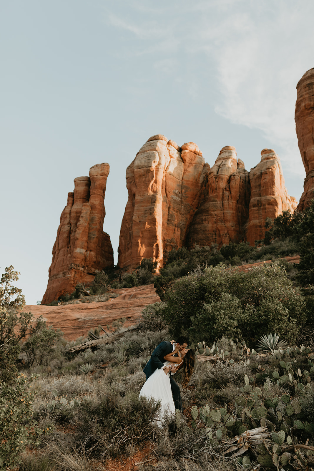 stunning couple pose together for their Sedona cathedral adventure engagement photos