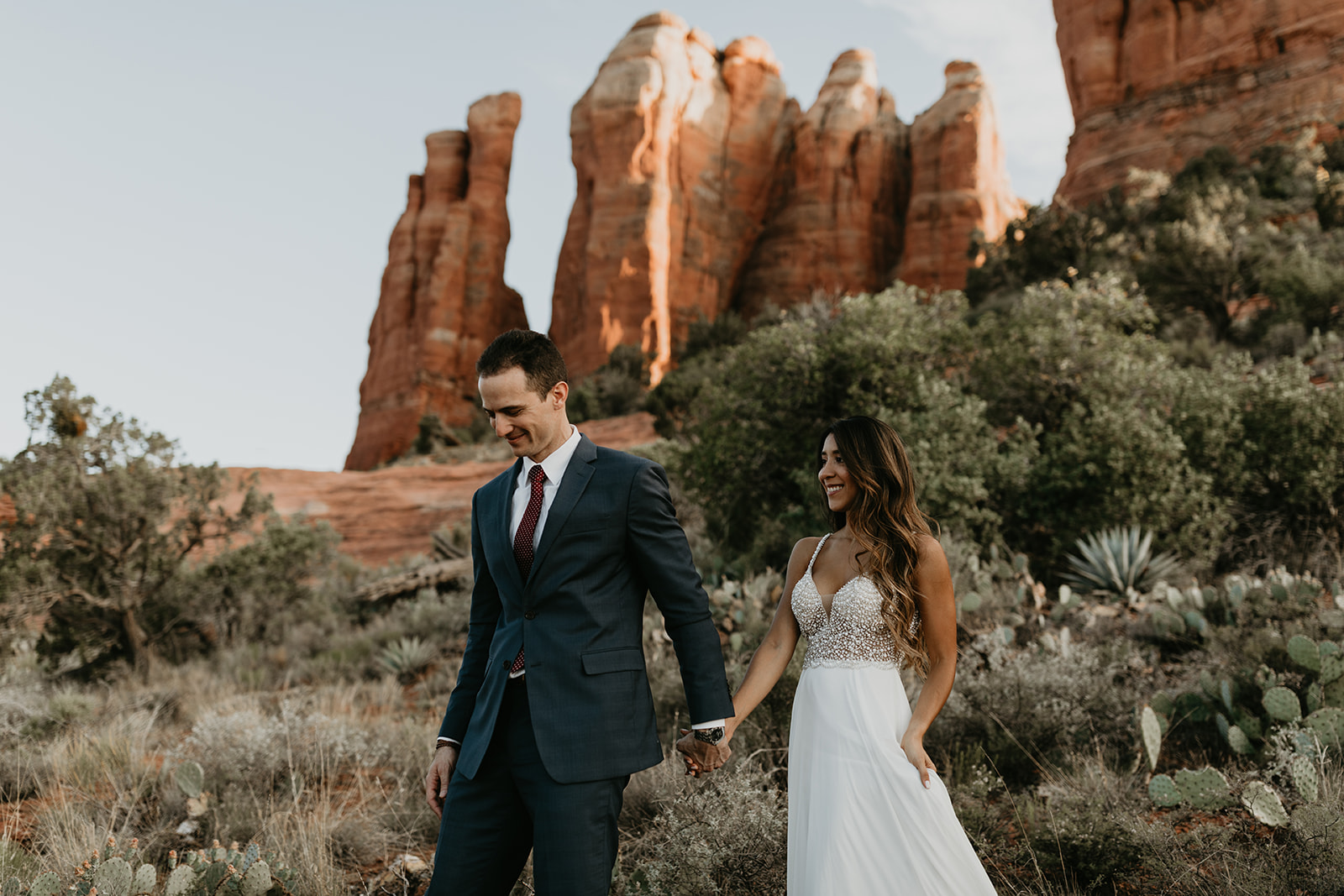 stunning couple pose together for their Sedona cathedral adventure engagement photos