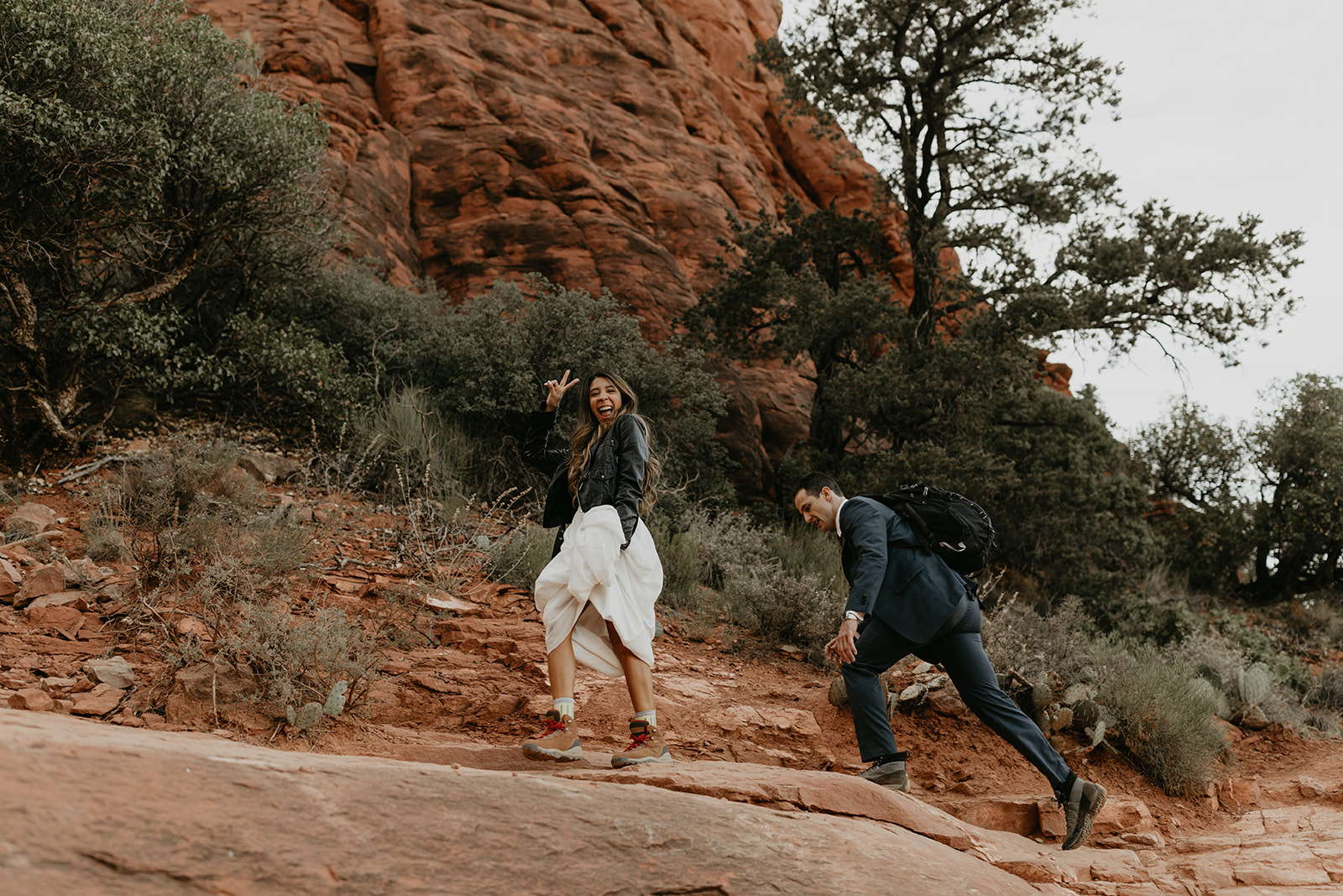 couple climb the rocks towards the summit 