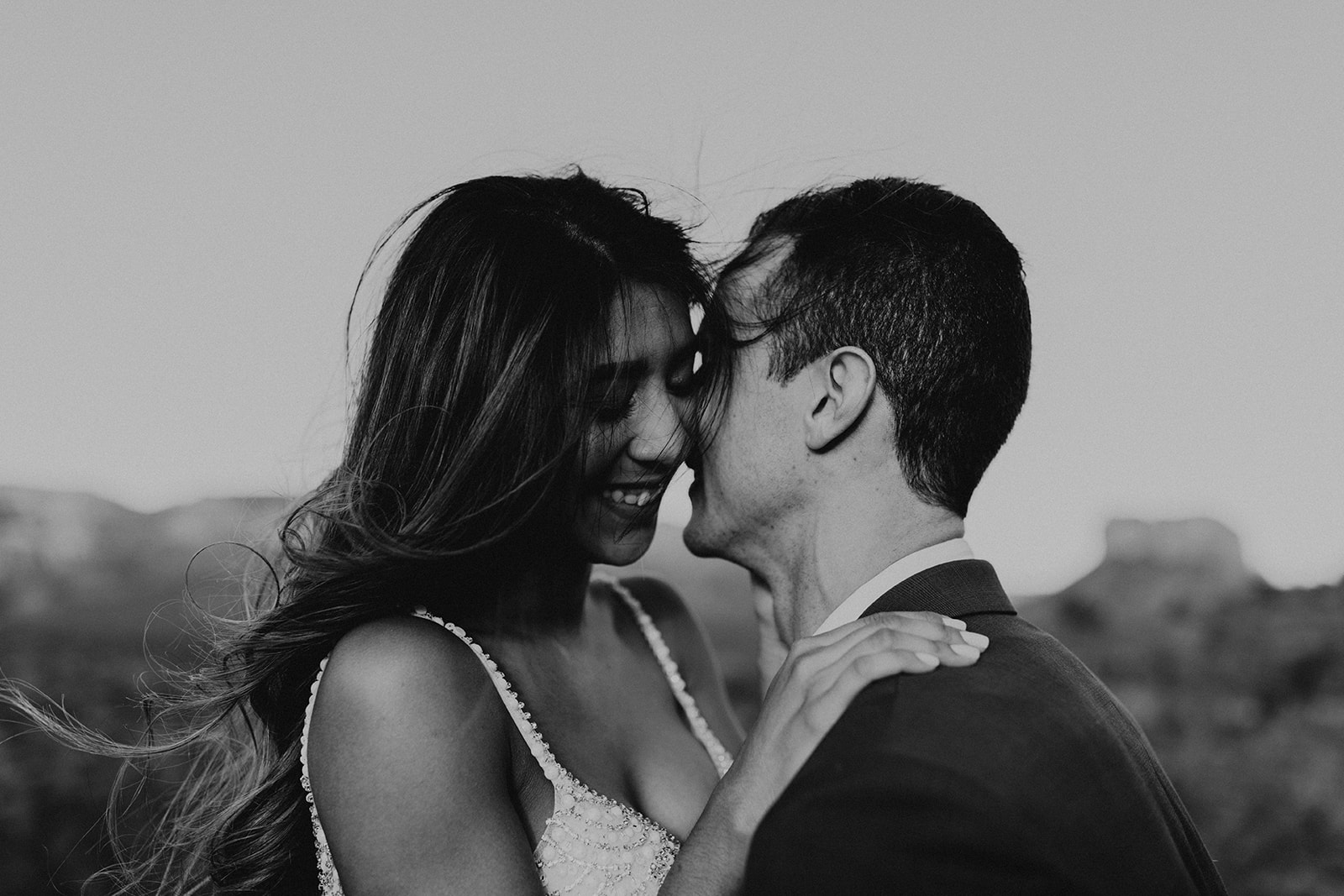 stunning couple pose together for their Sedona cathedral adventure engagement photos