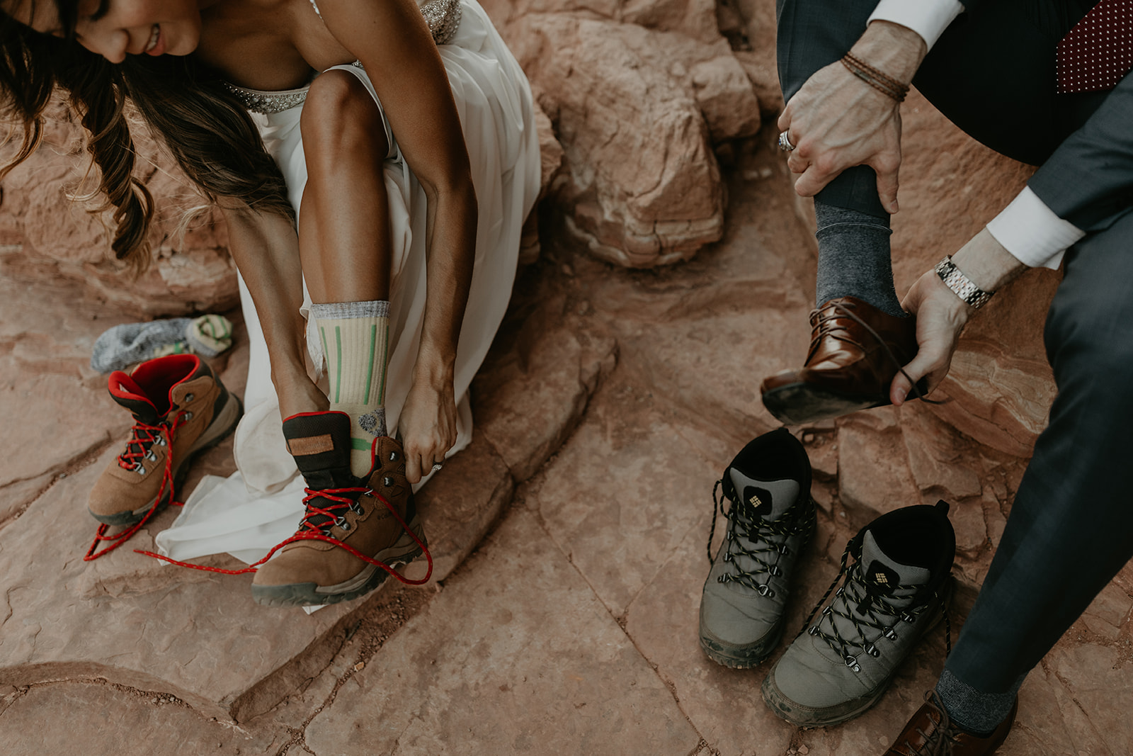 stunning couple change their shoes after their hike to Cathedral rock in the Arizona desert! 