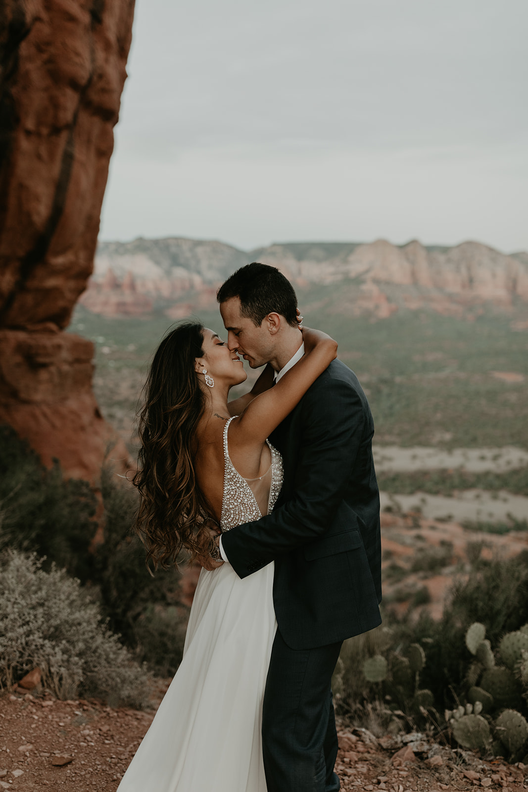 stunning couple pose together for their Sedona cathedral adventure engagement photos