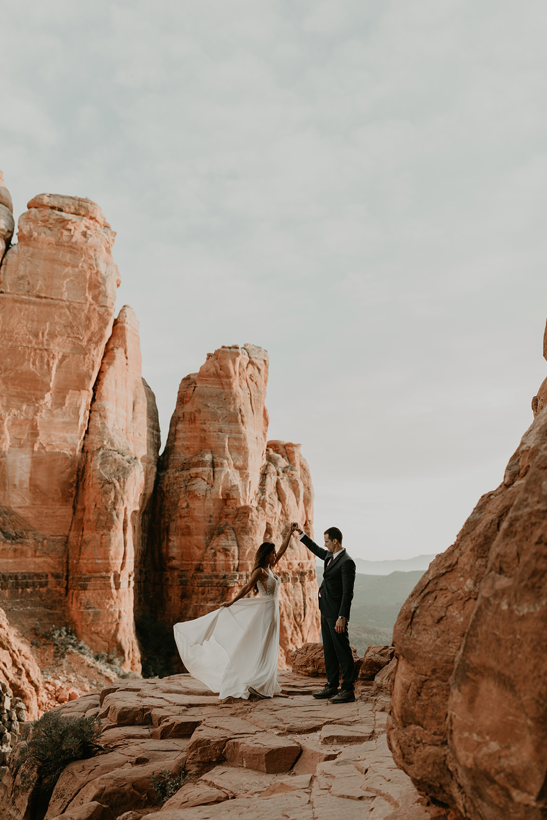 stunning couple pose together for their Sedona cathedral adventure engagement photos