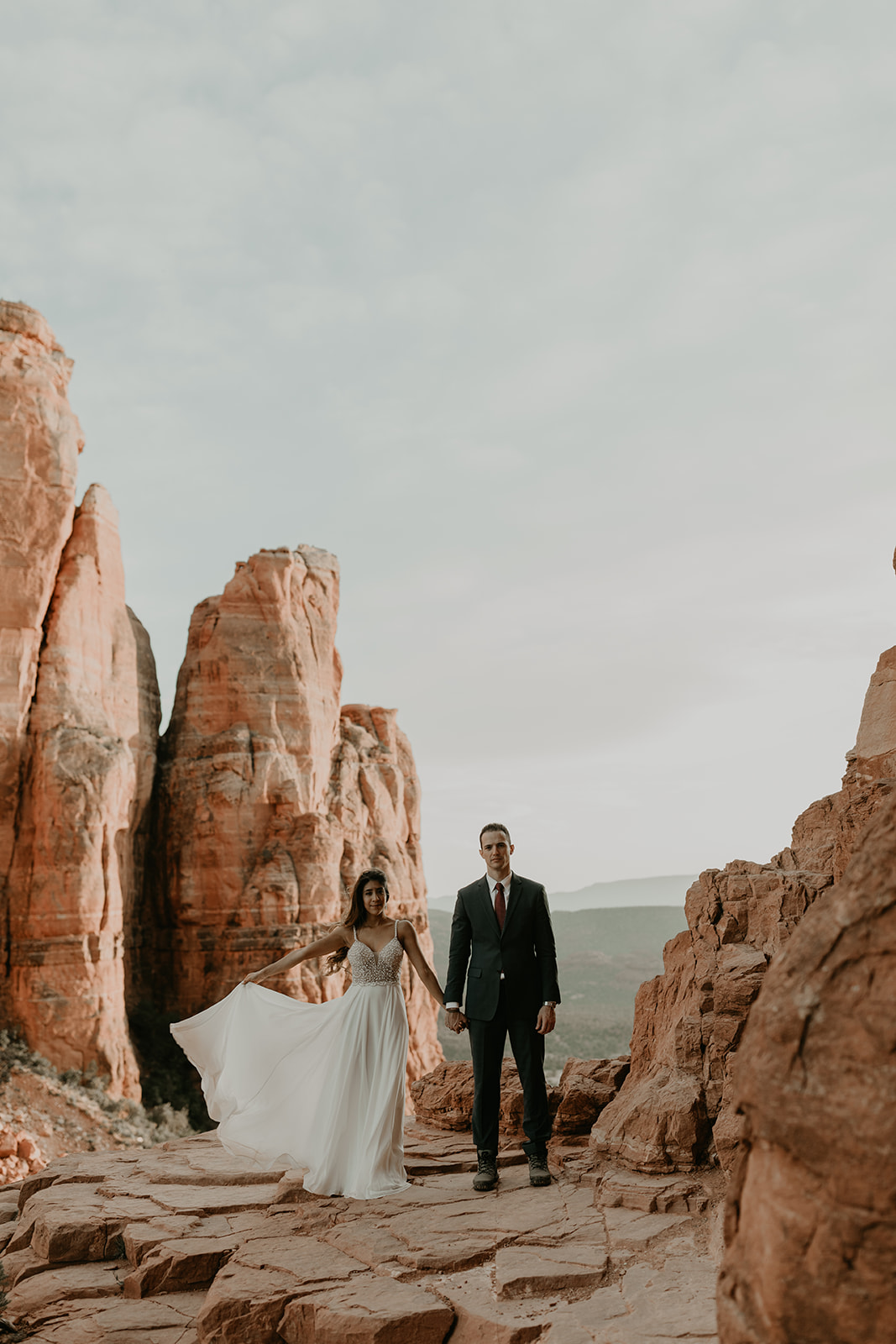 stunning couple pose together for their Sedona cathedral adventure engagement photos