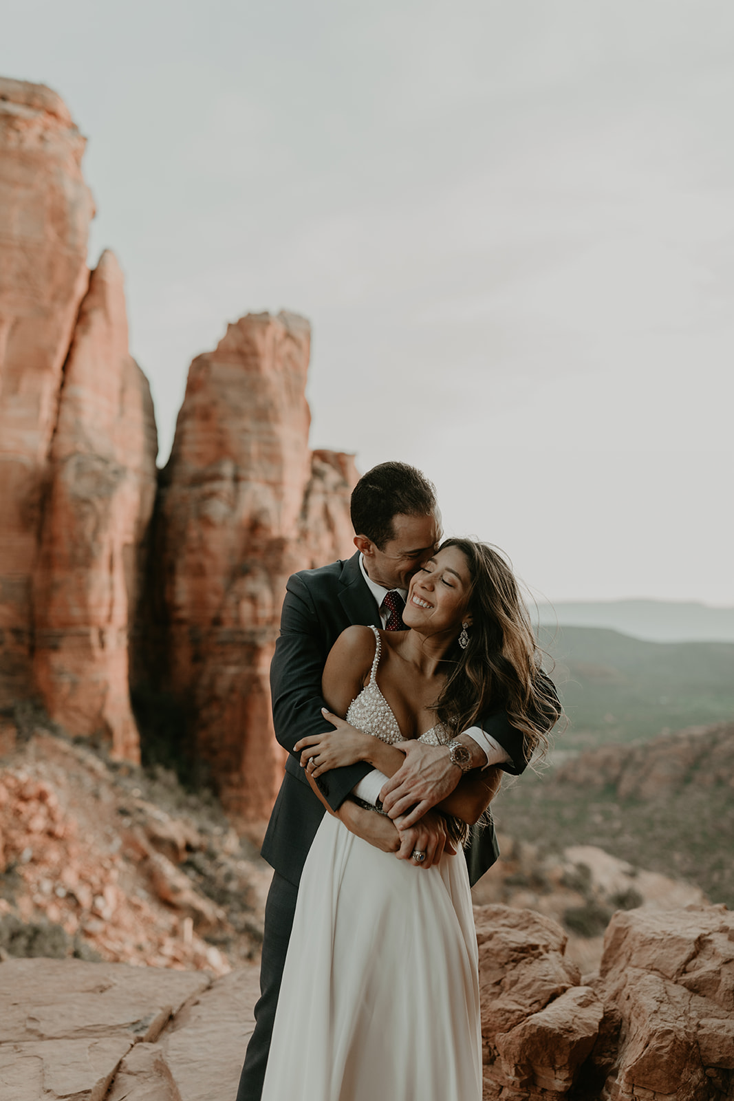 stunning couple pose together for their Sedona cathedral adventure engagement photos