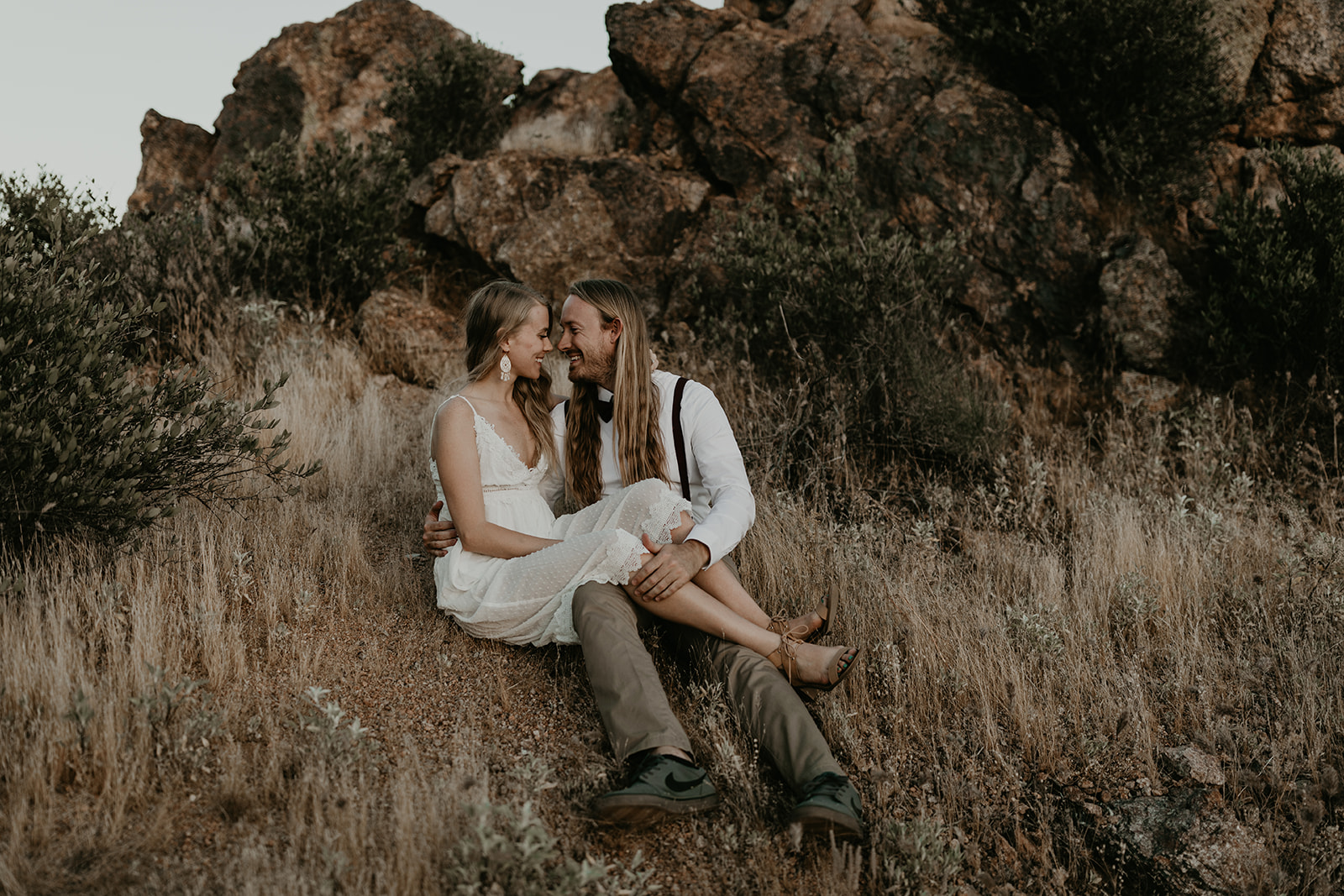 beautiful couple pose in the Arizona desert together during their Arizona lake engagement photoshoot