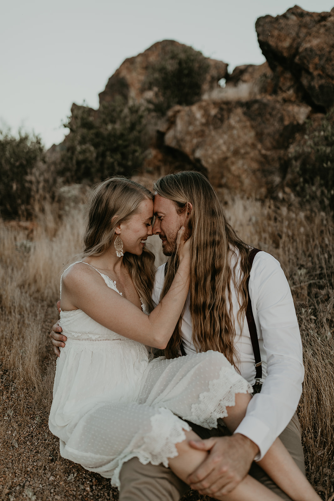 beautiful couple pose in the Arizona desert together during their Arizona lake engagement photoshoot