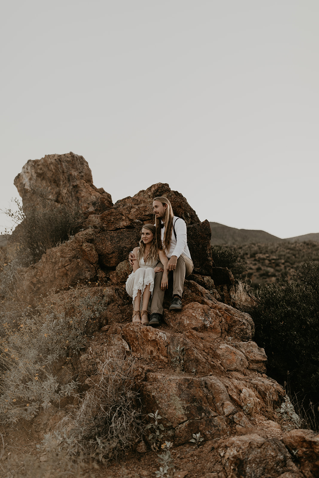 beautiful couple pose in the Arizona desert together during their Arizona lake engagement photoshoot