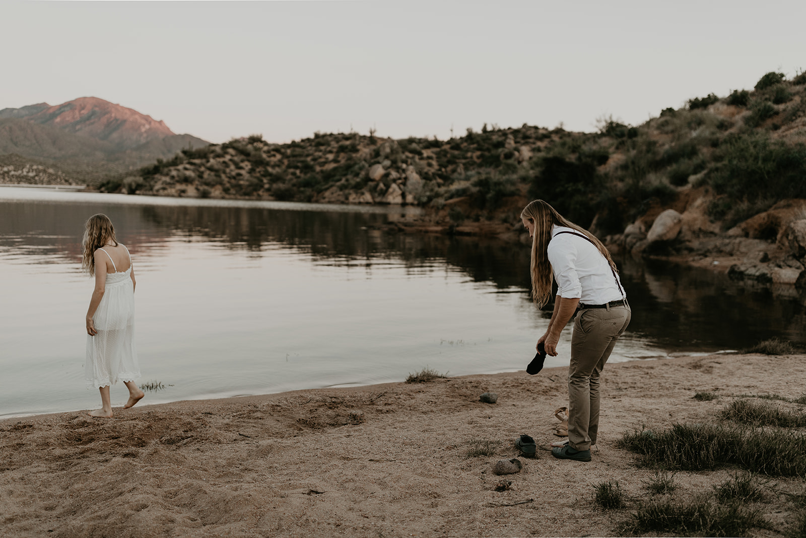 couple take off their shoes to enter Bartlett Lake