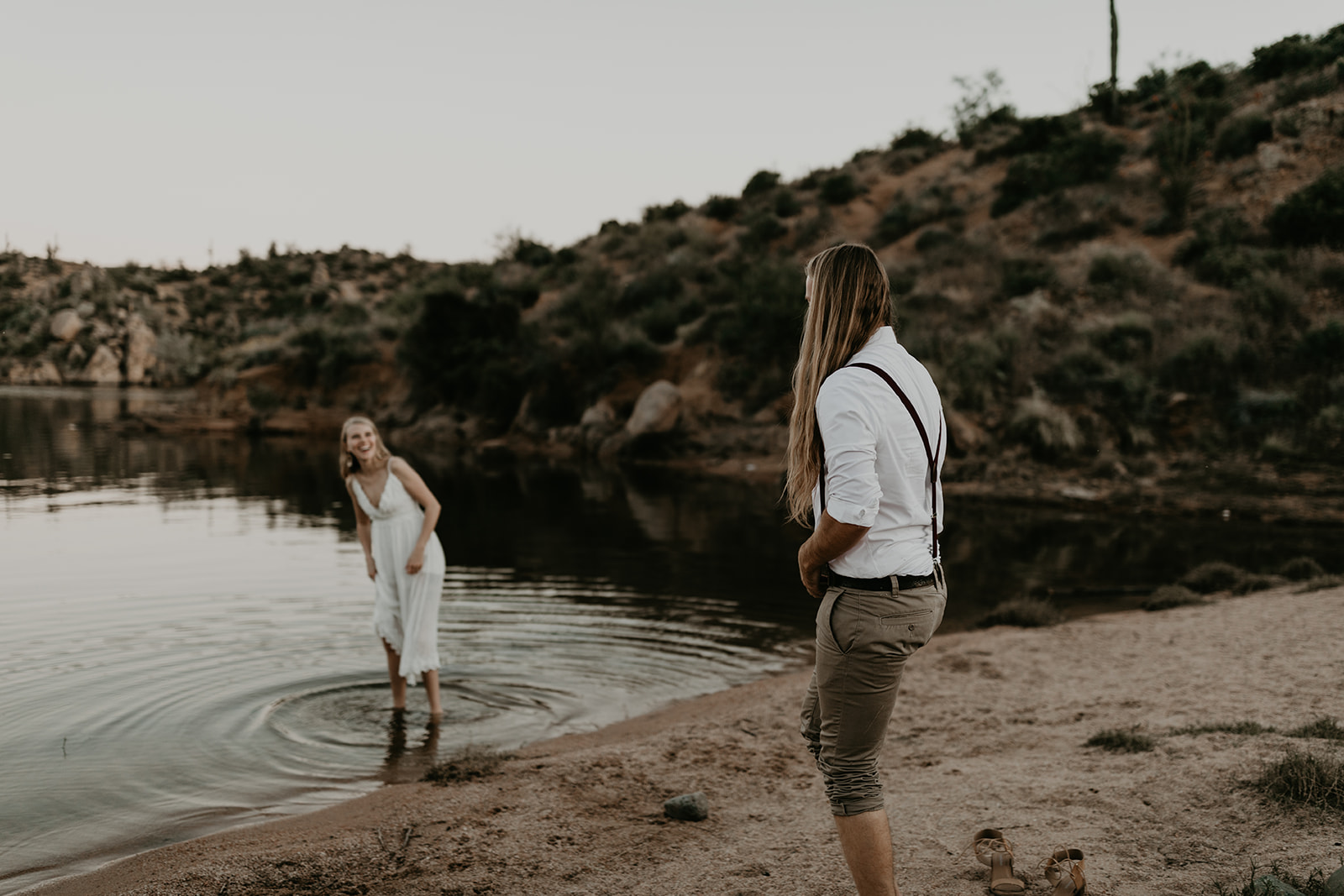 stunning couple play in Bartlett Lake during their Arizona engagement photoshoot