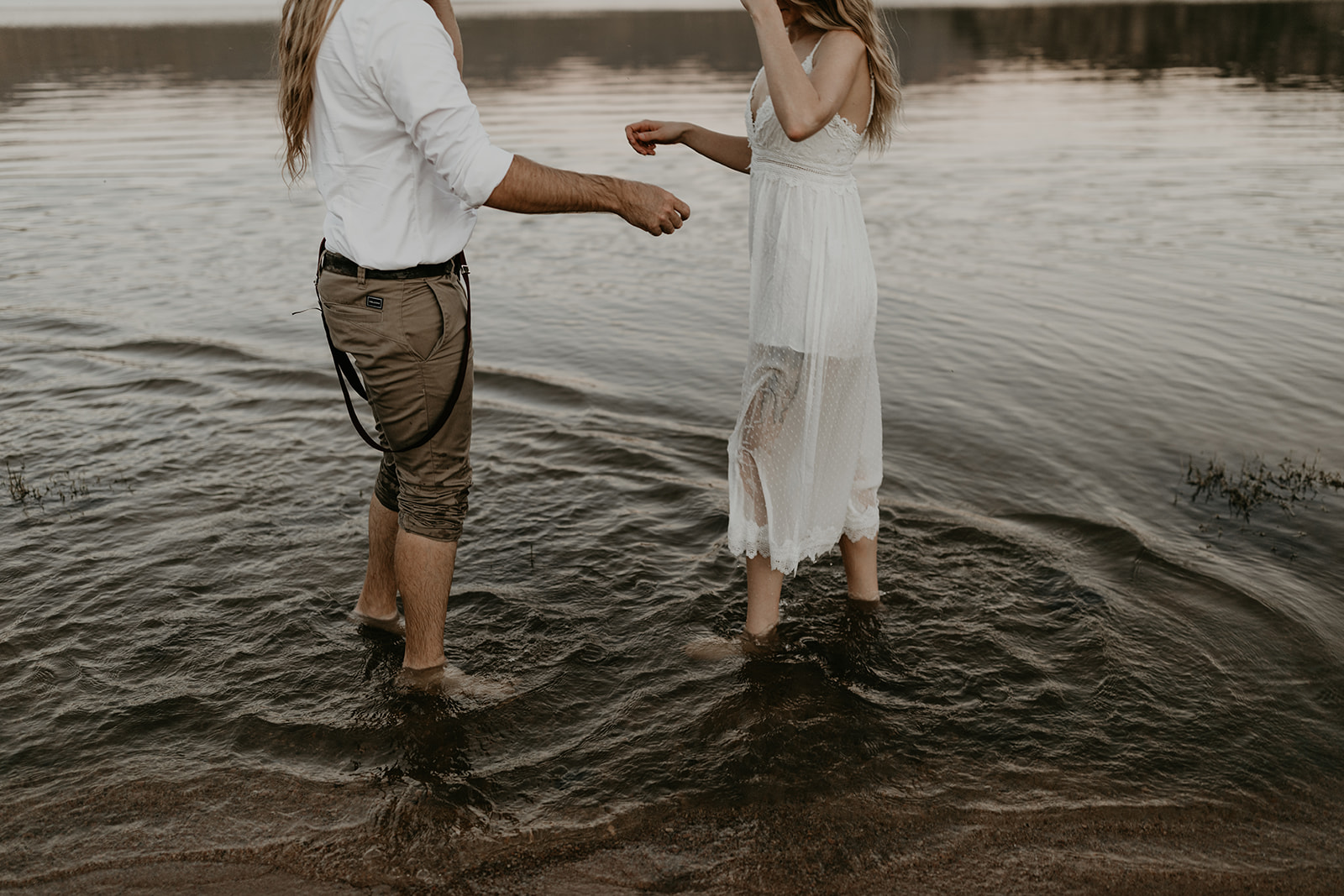 stunning couple play in Bartlett Lake during their Arizona engagement photoshoot